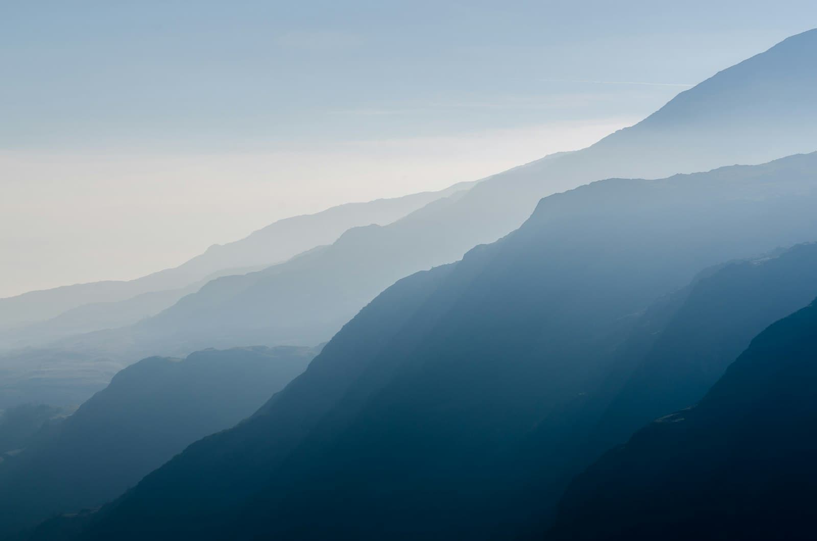 Forested ridges disappearing into layers of mist
