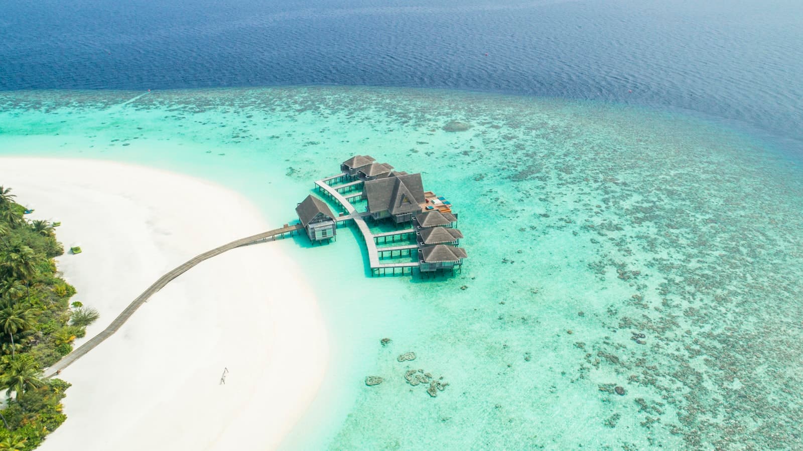 A private villa on stilts at the tip of a sandbank in clear shallow water